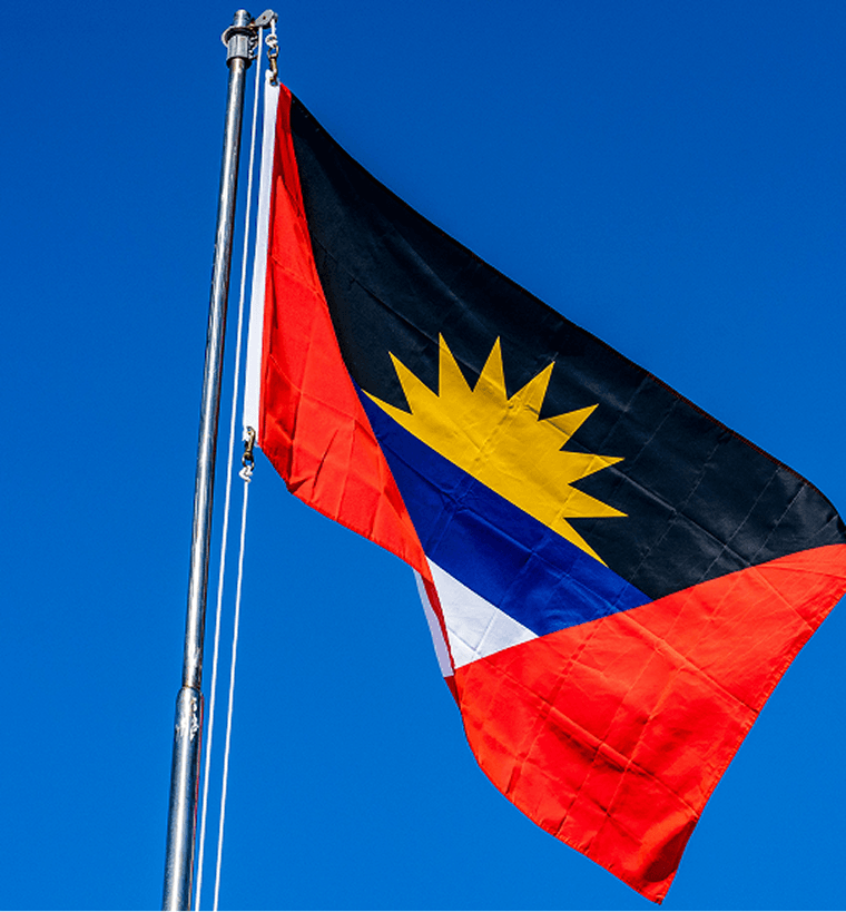 Better Flags | CiCLO Flags | Antigua and Barbuda flag waving on a flagpole against a clear blue sky.